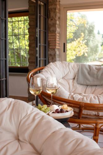 a table with two glasses of wine and a plate of food at The Lake Escape - Trevignano in Trevignano Romano