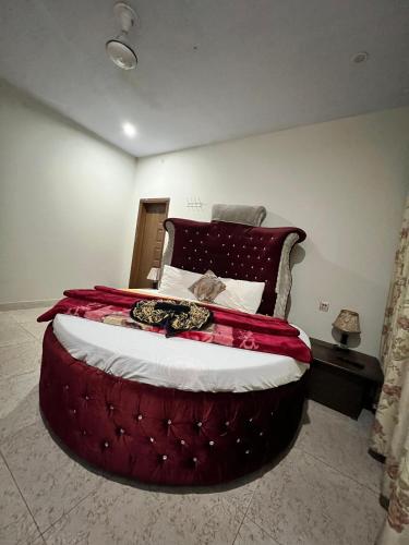 a bedroom with a large bed with a red comforter at Pine view Hotel Tranna Balakot in Hassa
