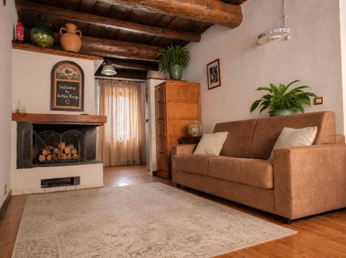 a living room with a couch and a fireplace at Antico Borgo in Brugnato
