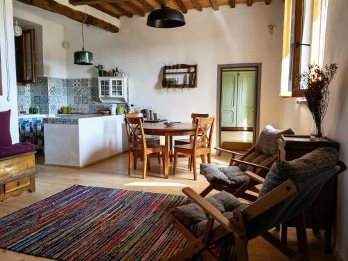 a kitchen and dining room with a table and chairs at La Salvia in Scansano