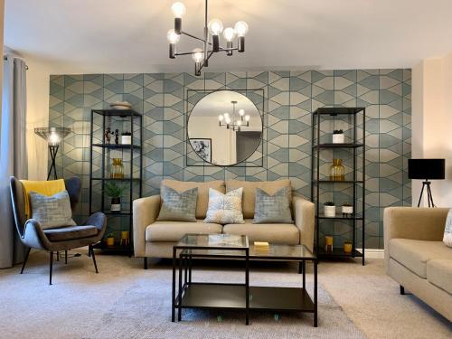 a living room with a couch and a mirror at The Stokesay Boutique Townhouse Ludlow in Ludlow