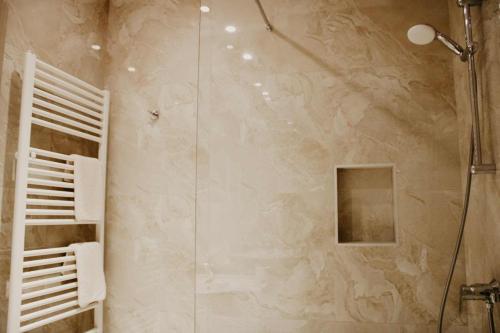 a bathroom with a shower with a glass door at Hotel Villa Matic in Neum