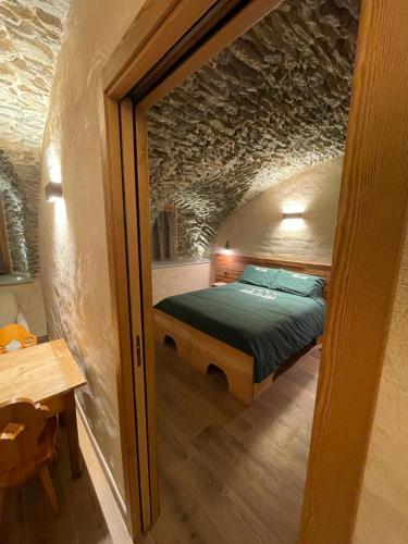 a bedroom with a bed in a small room at Affittacamere L'Abri in Etroubles