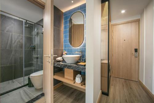 a bathroom with a sink and a toilet and a shower at MAY DE VILLE Prestige Hotel in Hanoi