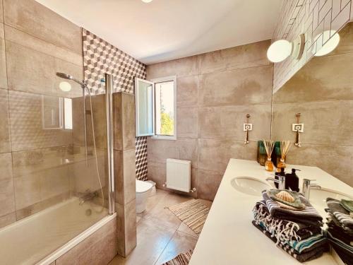 a bathroom with a sink and a shower and a tub at The Blue House in Larnaca