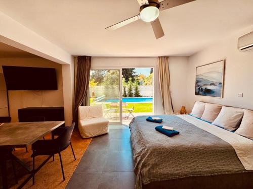 a hotel room with a bed and a table and a television at The Blue House in Larnaca