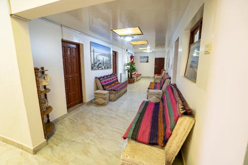 a hallway with couches and chairs in a room at Hostal Terra Sal - Bed, Breakfast, Garage & Salar de Uyuni Tours in Uyuni