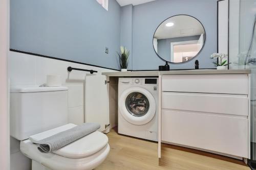 a bathroom with a washing machine and a mirror at Oasis Royal in Corralejo