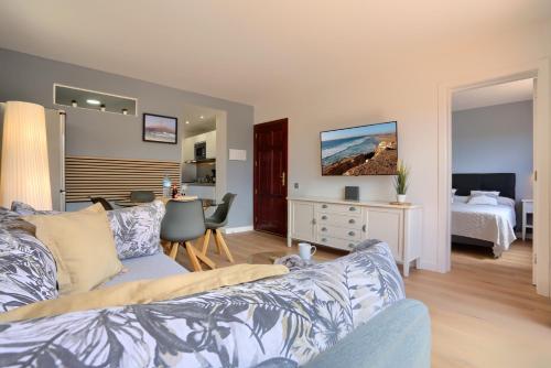 a living room with a couch and a bedroom at Oasis Royal in Corralejo