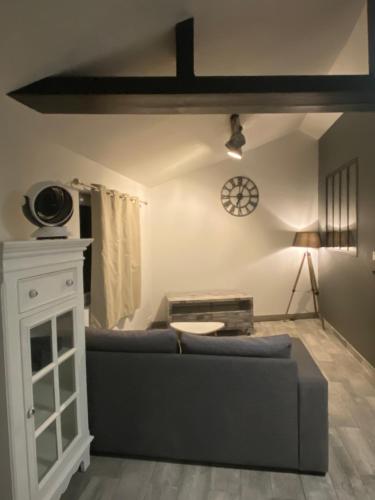 a living room with a couch and a table at Gilie beach in Saint-Brevin-les-Pins