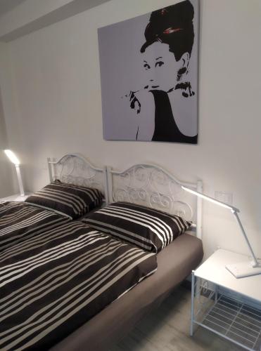 a bedroom with a bed with a picture on the wall at Casa Doris in Montabone