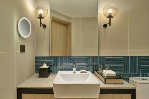 a bathroom with a sink and a toilet at Four Points by Sheraton Johor Bahru in Kampong Telok Jawa