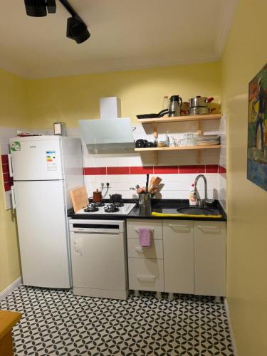 a kitchen with a white refrigerator and a stove at Go to Sleep in Gelibolu