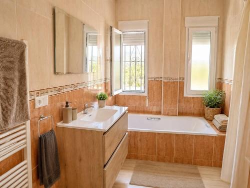 a bathroom with a tub and a sink and a mirror at Casa Castillo in Huércal-Overa