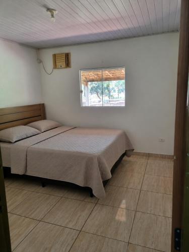 a bedroom with two beds and a window at KmX in Campo Grande