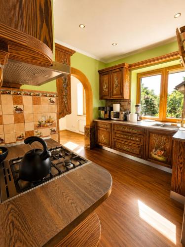 a kitchen with a black tea kettle on the stove at Flower 18 in Jūrmala