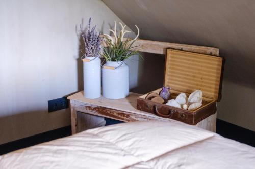 a table with two vases on top of a bed at B&B by lin in Dodewaard