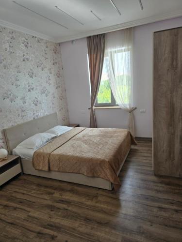 a bedroom with a large bed and a window at T'teni in Urtsʼadzor