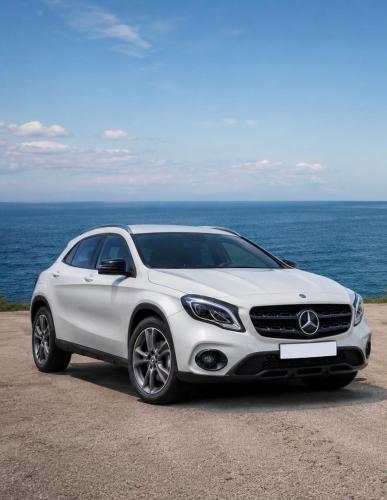 a white mercedes benz car parked next to the ocean at iLocal Premium Services suite in Zefiría