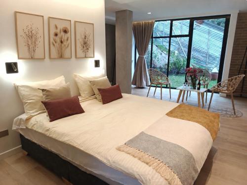 a bedroom with a large bed and a dining room at Iwana stay in Bogotá