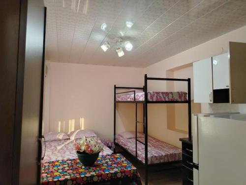 a room with two bunk beds and a kitchen at Tamari in Ureki