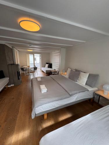 a bedroom with a large bed and a living room at Vinkelgata 20 Guesthouse in Stavanger