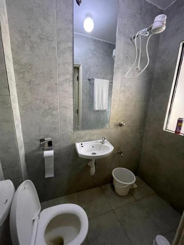 a bathroom with a toilet and a sink at Unique one bedroom with pool in Nairobi