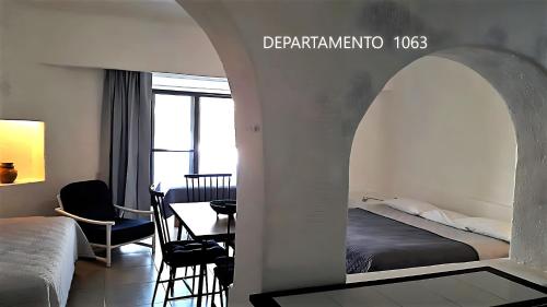 a hotel room with a bed and a dining room at Puerto Las Hadas Apartamentos 1065-1063-764 in Manzanillo