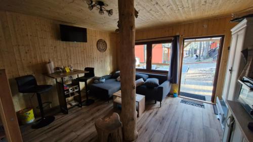 a living room with a couch and a table at Chata Veverka in Doksy
