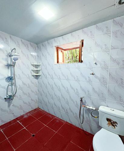 a bathroom with a toilet and a window at Gabala Grean Villa in Gabala