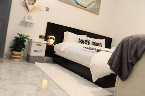 a bedroom with a large bed with a black headboard at Kilimavista Homes studio D2 in Kimana