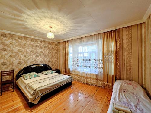 a bedroom with a bed and a window at Gabala Grean Villa in Gabala