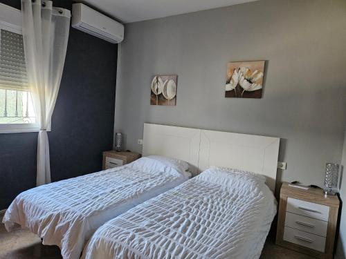 a bedroom with two beds and a window at Villa - Sleeps 4 - Pool - Patio - Parking in Arboleas