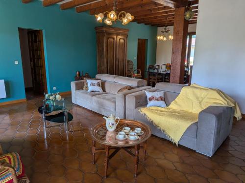 a living room with a couch and a table at Le Petiou Landais in Soustons
