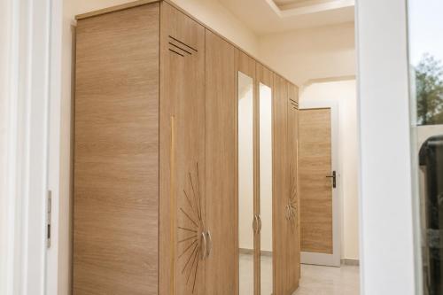 a wooden cabinet in a room with a door at Villas avec piscine in Taguermess