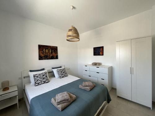 a bedroom with a bed with two towels on it at Casa Monte y Mar in Morro del Jable