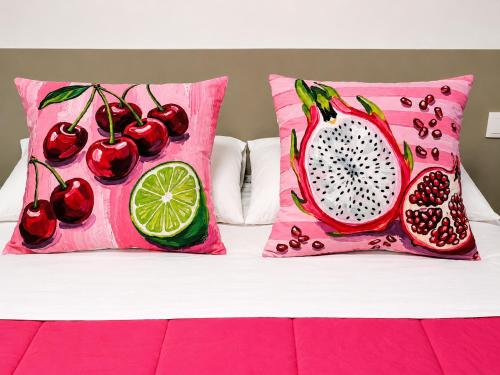 a bed with two pillows with fruit on it at Aveiro Ria View in Aveiro