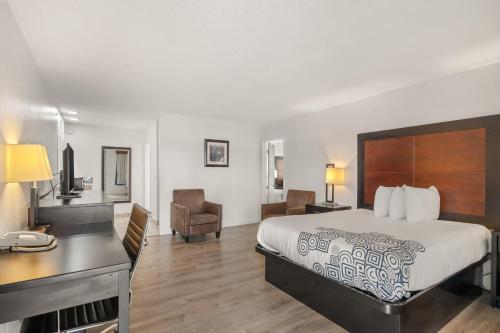 a hotel room with a bed and a desk at Pine Tree inn in Medford