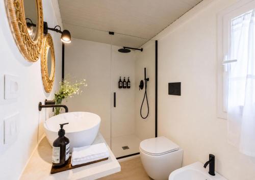 a bathroom with a sink and a toilet and a shower at Ziran in Noto