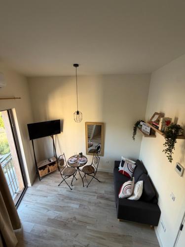 a living room with a couch and a table at Tivat Cozy Studio in Tivat