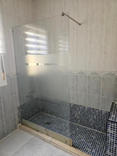 a shower with a glass door in a bathroom at Villa - Sleeps 4 - Pool - Patio - Parking in Arboleas