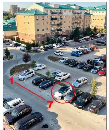 an aerial view of a parking lot with cars parked at Adina Cosmopolis in Ştefăneştii de Jos