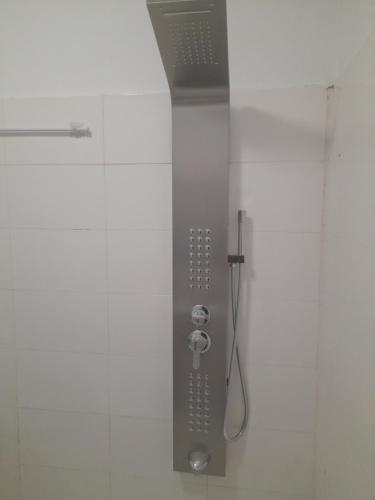 a shower with a shower head in a bathroom at Residence du fromager in Bouaké
