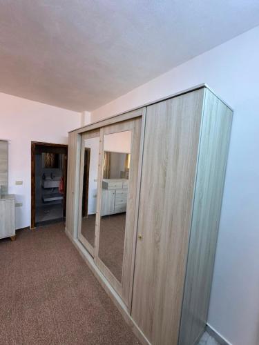 a large wooden cabinet in a room with a bedroom at اطلالة سوف in Jerash