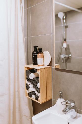 a bathroom with a sink and a mirror at Lavandas apartamenti in Ikšķile