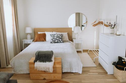 a bedroom with a bed and a mirror at Lavandas apartamenti in Ikšķile
