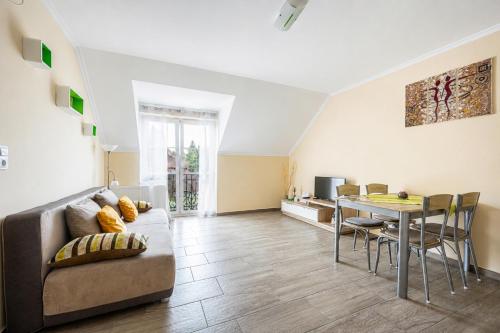 a living room with a couch and a table at Gere Art&Exclusive Apartments in Harkány