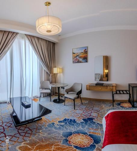 a hotel room with a bed and a table at La Zona Continental Hotel in Dubai
