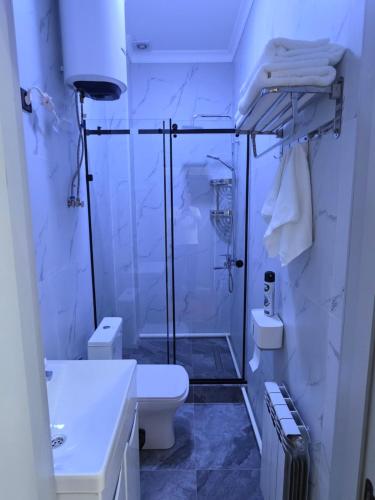 a bathroom with a shower and a toilet and a sink at TOI AT-BASHY HOTEl in At-Bashy