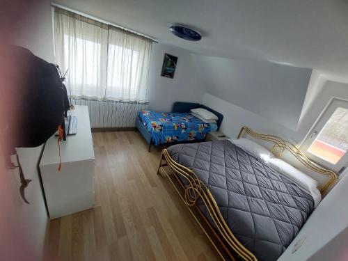 a small bedroom with a bed and a table at Casa Curcubeu in Ceahlău